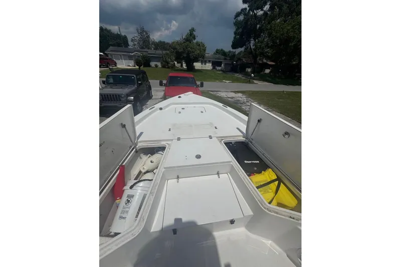 Slide: The Image of 2016 Sea Hunt BX 24 BR boat deck with open storage compartments. - 9