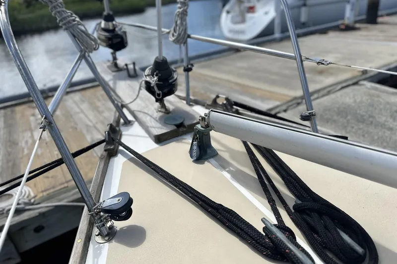 Slide: The Image of Close-up of 1982 Cape Dory 30 sailboat deck with rigging and dock background. - 25