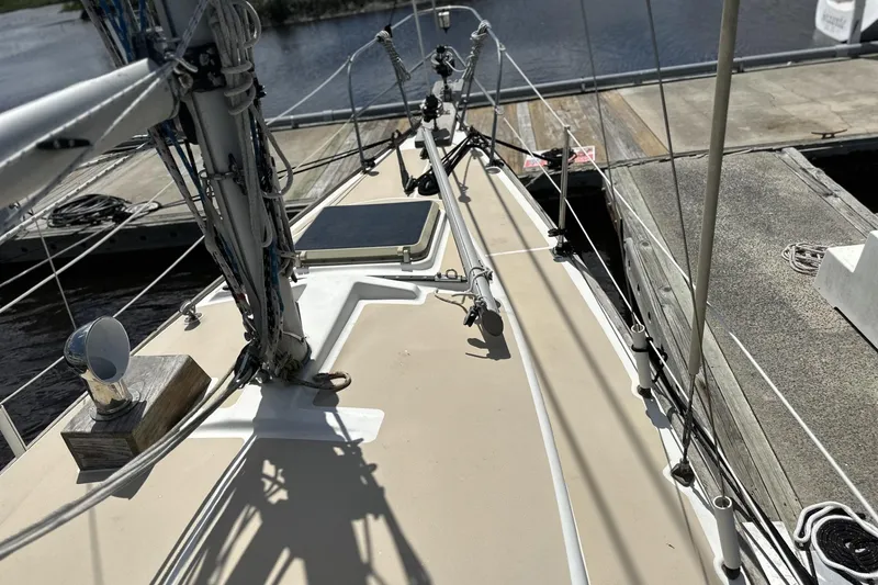 Slide: The Image of 1982 Cape Dory 30 sailboat deck, docked at marina, with visible rigging and fittings. - 30