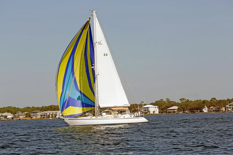 The Image of Sailing yacht Hylas 49CC 2012 with colorful spinnaker on calm water. - 0