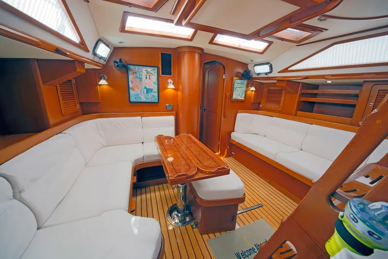 Slide: The Image of Luxurious interior of 2012 Hylas 49CC yacht with elegant wood finish and white seating. - 102