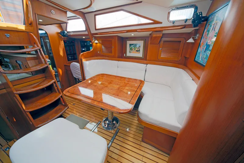 Slide: The Image of Luxurious interior of 2012 Hylas 49CC yacht with wooden finishes and white seating. - 104