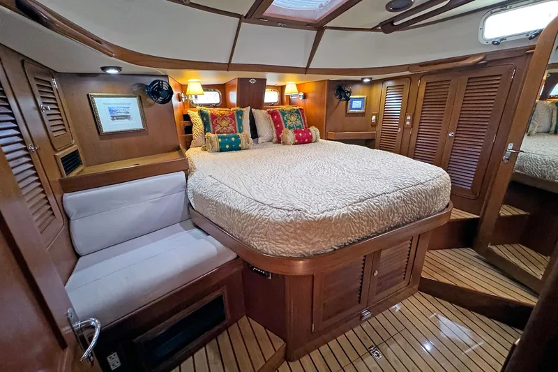 Slide: The Image of Luxurious 2012 Hylas 49CC yacht cabin with cozy bed and elegant wood finish. - 105