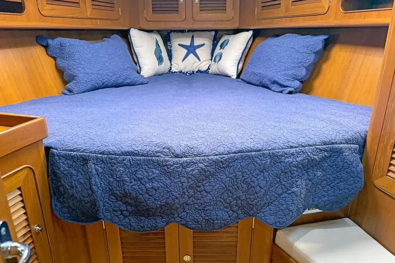 Slide: The Image of Cozy cabin bed with blue quilt and nautical pillows in 2012 Hylas 49CC yacht. - 106