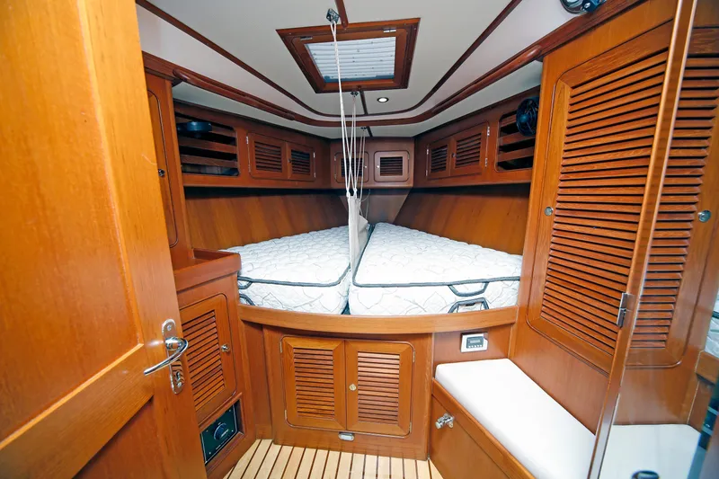 Slide: The Image of Cozy cabin interior of 2012 Hylas 49CC yacht with wooden finish and twin beds. - 109