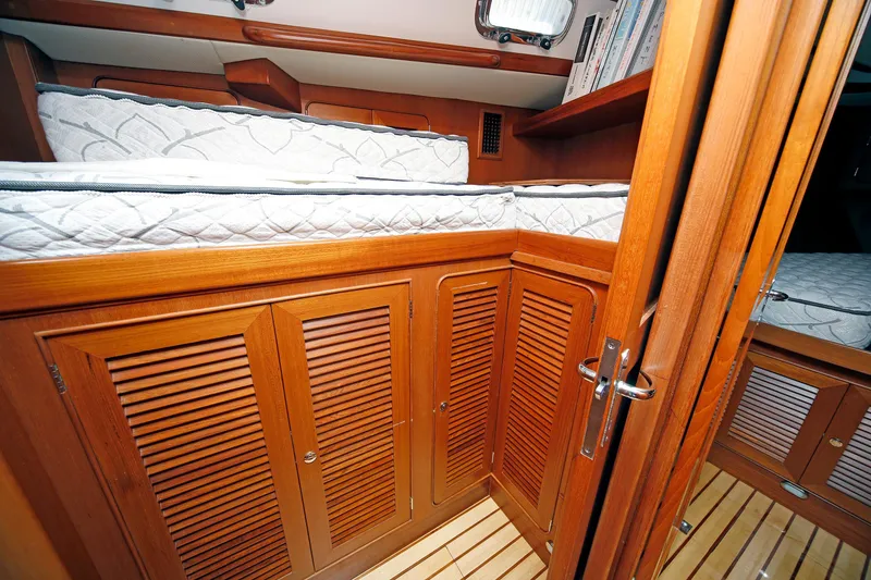 Slide: The Image of Interior of 2012 Hylas 49CC yacht with wooden cabinetry and bunk beds. - 110