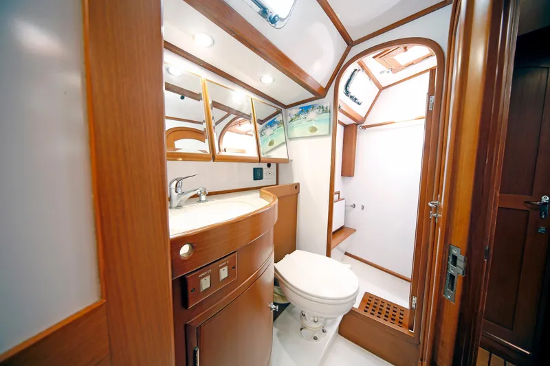 Slide: The Image of Luxurious 2012 Hylas 49CC yacht bathroom with wooden cabinetry and modern fixtures. - 112