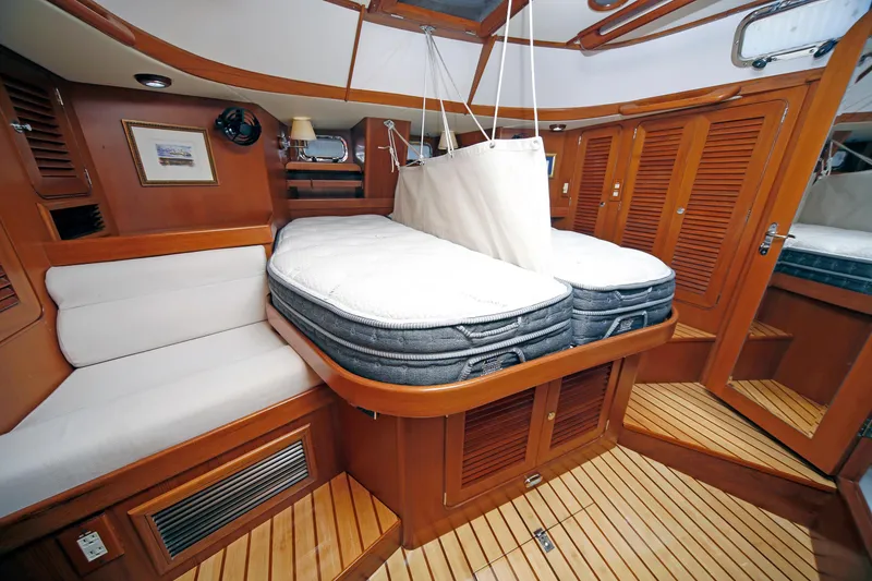 Slide: The Image of Luxurious cabin interior of 2012 Hylas 49CC yacht with wooden finishes and comfortable bedding. - 113