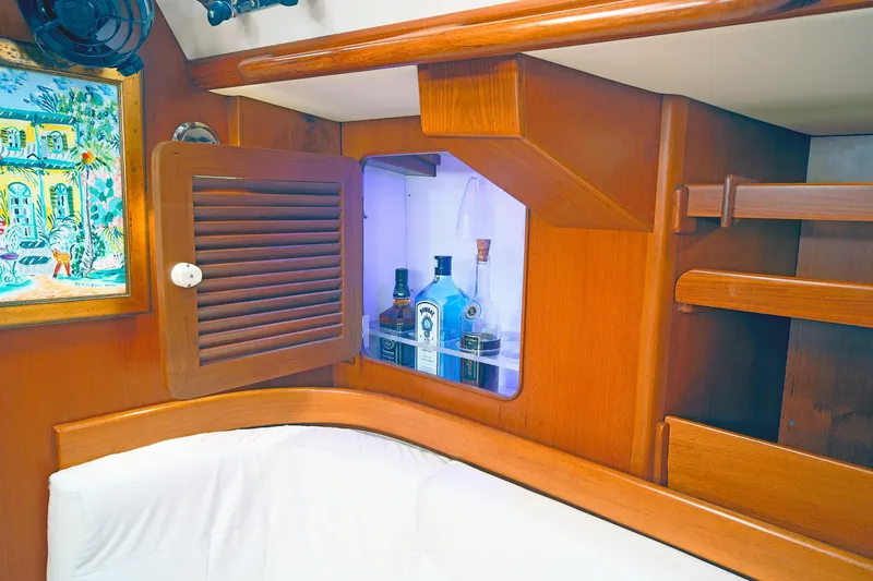 Slide: The Image of Interior of 2012 Hylas 49CC yacht with wooden cabinetry and liquor storage. - 116