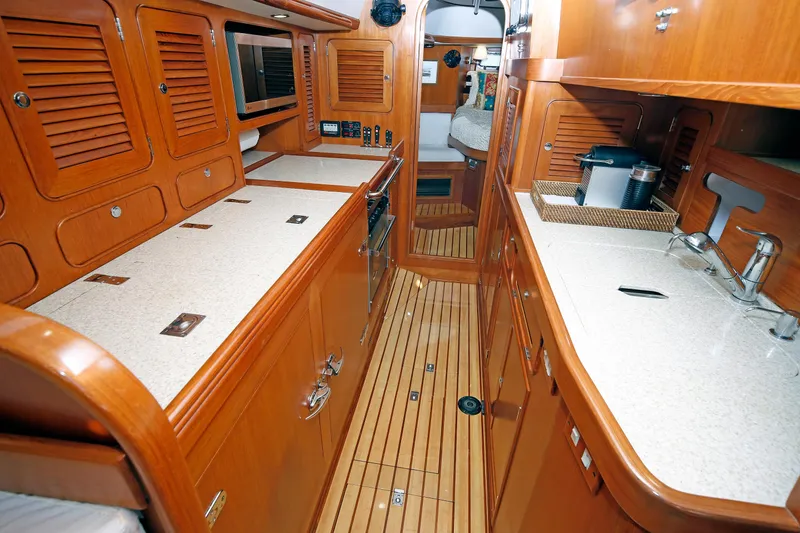 Slide: The Image of Luxurious interior of 2012 Hylas 49CC yacht with wooden cabinetry and modern amenities. - 119