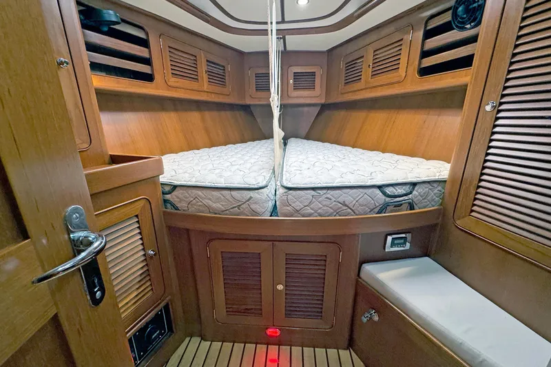 Slide: The Image of Cozy cabin interior of 2012 Hylas 49CC yacht with wooden finish and comfortable bedding. - 124