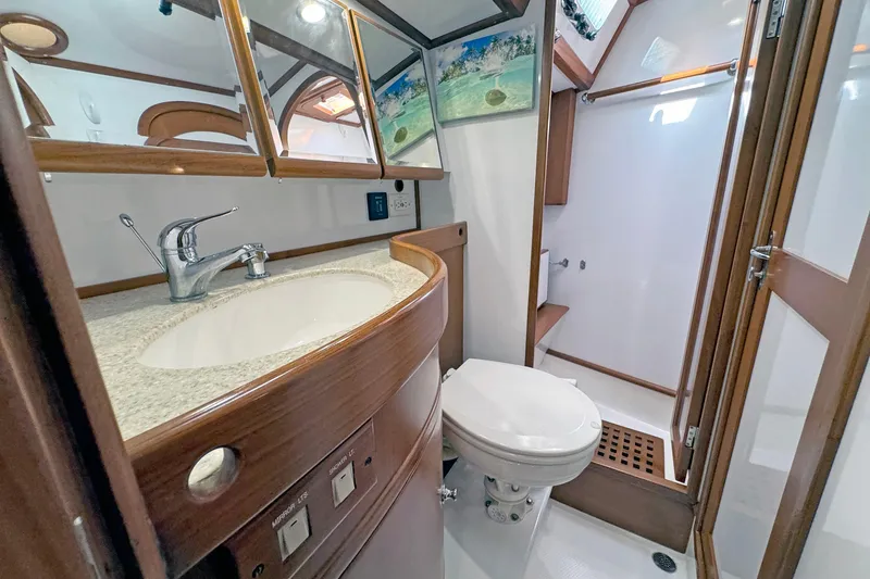 Slide: The Image of Luxurious 2012 Hylas 49CC yacht bathroom with wooden accents and modern fixtures. - 125