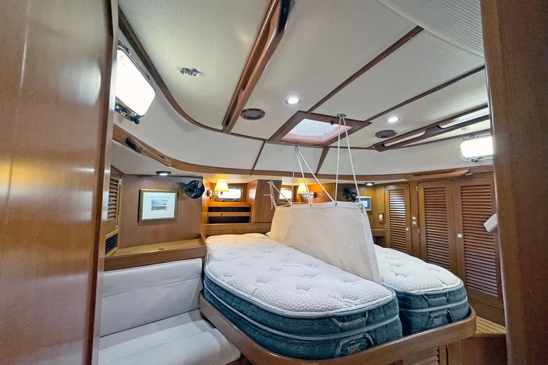 Slide: The Image of Luxurious 2012 Hylas 49CC yacht cabin with twin beds and elegant wood finish. - 129
