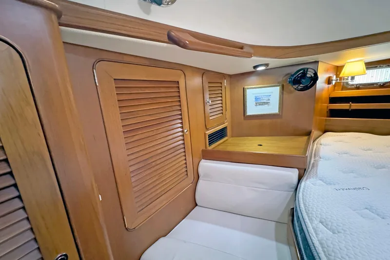 Slide: The Image of 2012 Hylas 49CC yacht interior with wooden cabinetry and cozy sleeping area. - 131