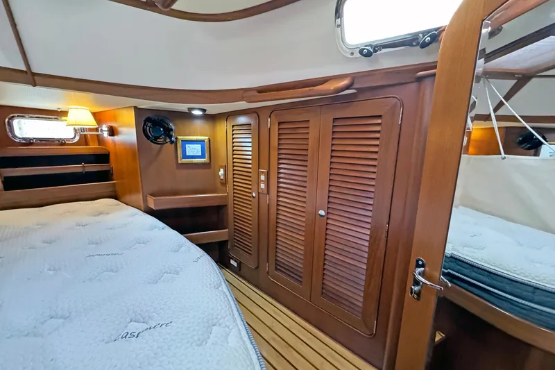 Slide: The Image of Luxurious 2012 Hylas 49CC yacht cabin with wooden interior and cozy bed. - 133