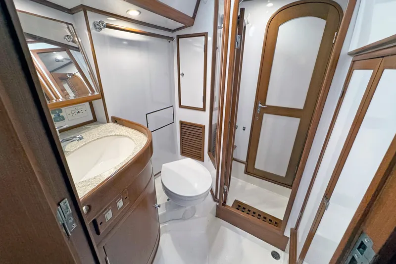 Slide: The Image of Luxurious 2012 Hylas 49CC yacht bathroom with wooden accents and modern fixtures. - 136
