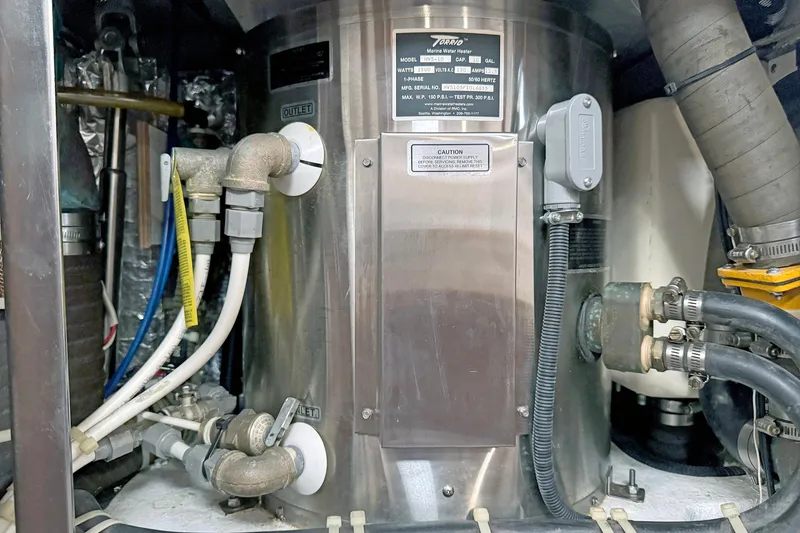 Slide: The Image of Hylas 49CC 2012 marine water heater with pipes and wiring connections. - 137