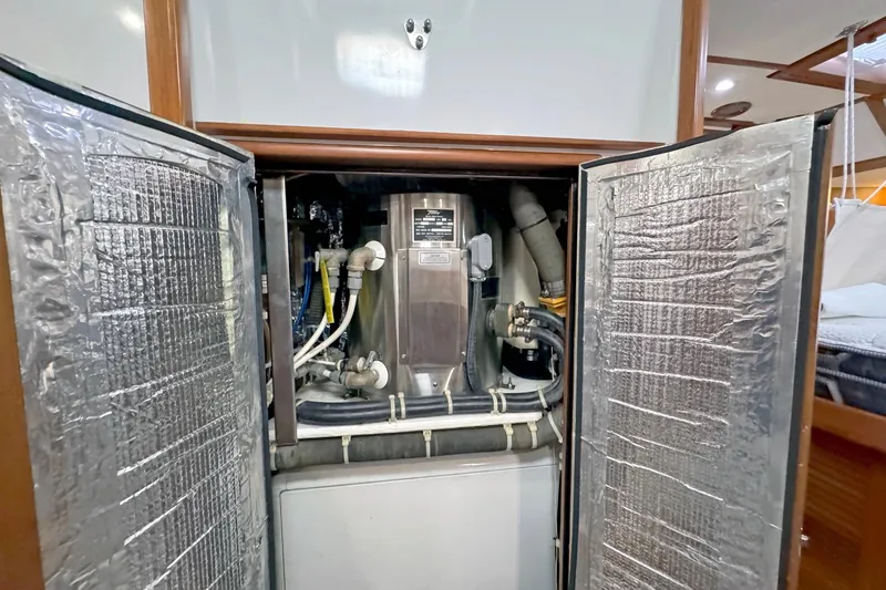 Slide: The Image of Engine compartment of a 2012 Hylas 49CC yacht, showcasing mechanical components and insulation. - 138