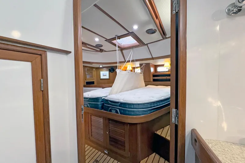 Slide: The Image of Luxurious 2012 Hylas 49CC yacht interior with cozy bedroom and elegant wood finishes. - 141
