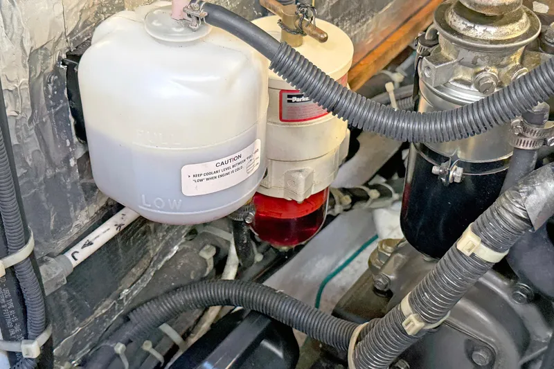 Slide: The Image of Engine compartment of a 2012 Hylas 49CC with coolant reservoir and fuel filter. - 148