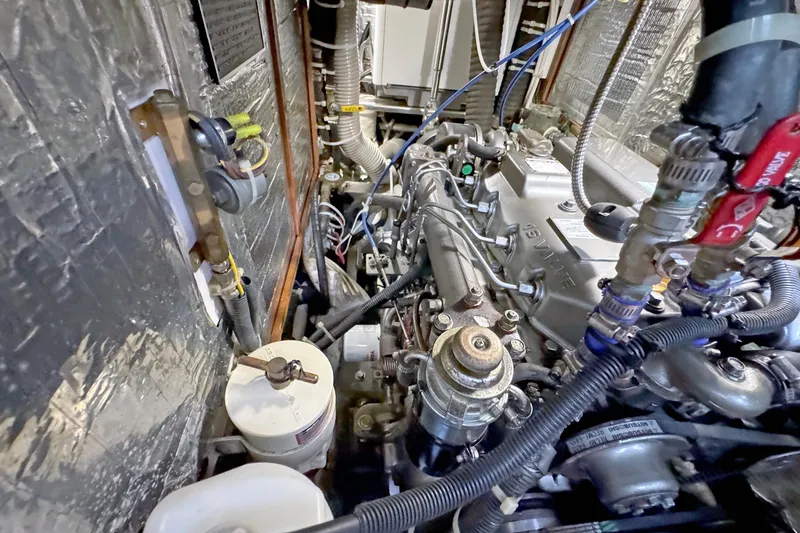 Slide: The Image of Engine compartment of a 2012 Hylas 49CC yacht, showcasing detailed mechanical components. - 154