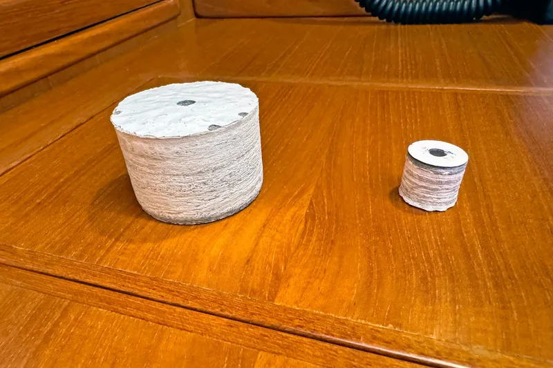 Slide: The Image of Two cylindrical objects on a wooden surface, showcasing different sizes and textures. - 157