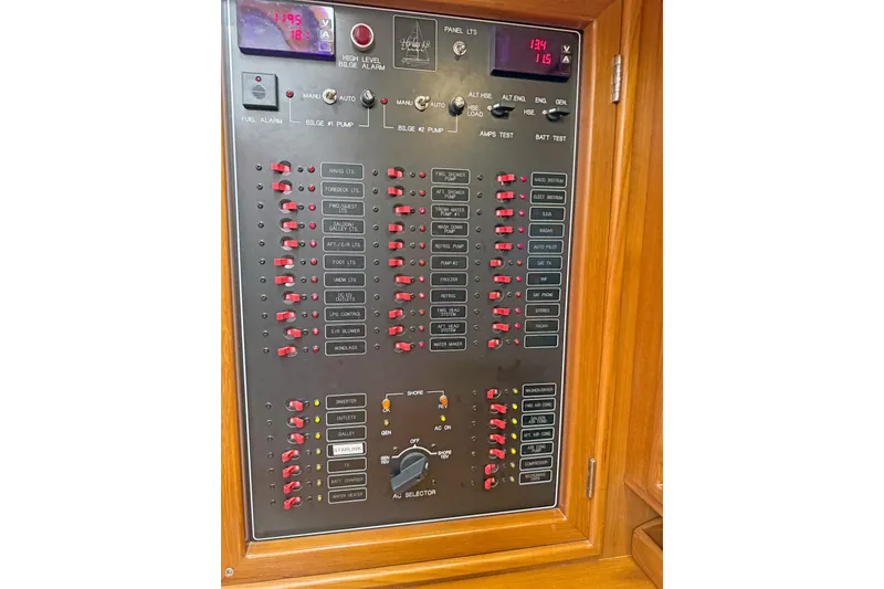Slide: The Image of Electrical control panel on a 2012 Hylas 49CC yacht, featuring switches and indicators. - 160