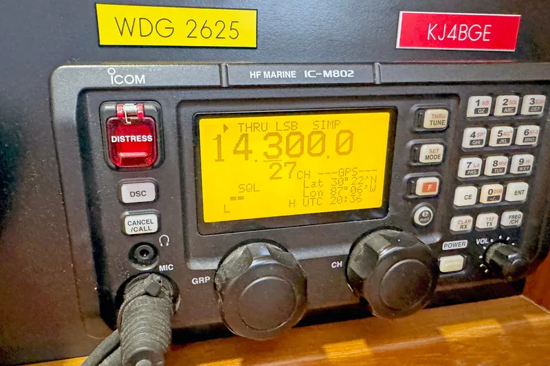 Slide: The Image of Marine radio equipment with distress button, displaying frequency 14.300.0, on a 2012 Hylas 49CC. - 166