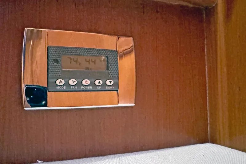 Slide: The Image of Thermostat control panel on a Hylas 49CC yacht, 2012 model, mounted on wooden surface. - 174