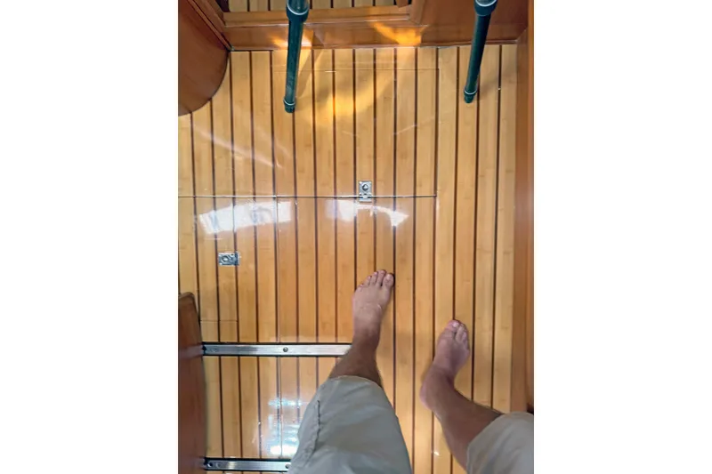 Slide: The Image of Bare feet on polished wooden floor of 2012 Hylas 49CC yacht interior. - 175