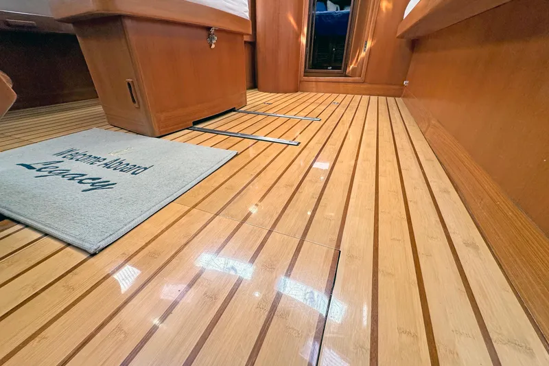 Slide: The Image of Polished wooden floor of 2012 Hylas 49CC yacht interior with welcome mat. - 181