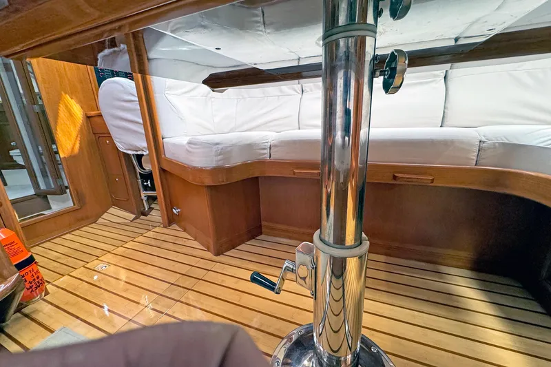 Slide: The Image of Interior of 2012 Hylas 49CC yacht with wooden flooring and white cushioned seating. - 182