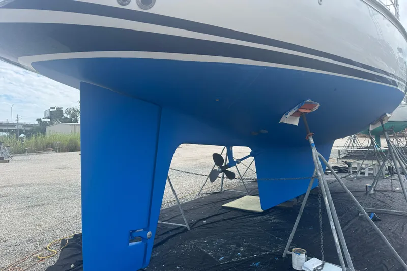 Slide: The Image of Hylas 49CC 2012 sailboat on stands, blue hull, visible propeller and rudder. - 184