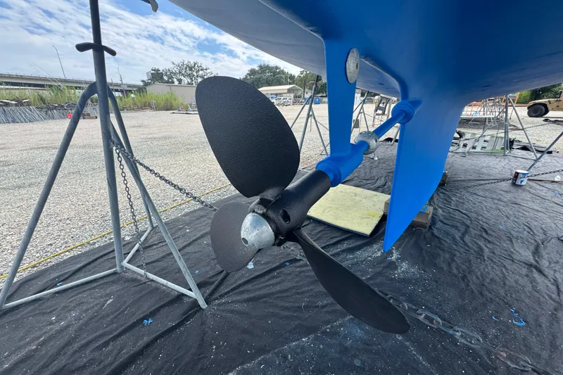 Slide: The Image of Propeller of a 2012 Hylas 49CC sailboat on a stand, with blue hull. - 186