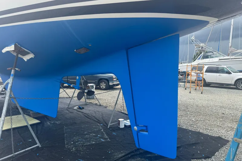 Slide: The Image of Blue hull of a 2012 Hylas 49CC sailboat on stands in a boatyard. - 195