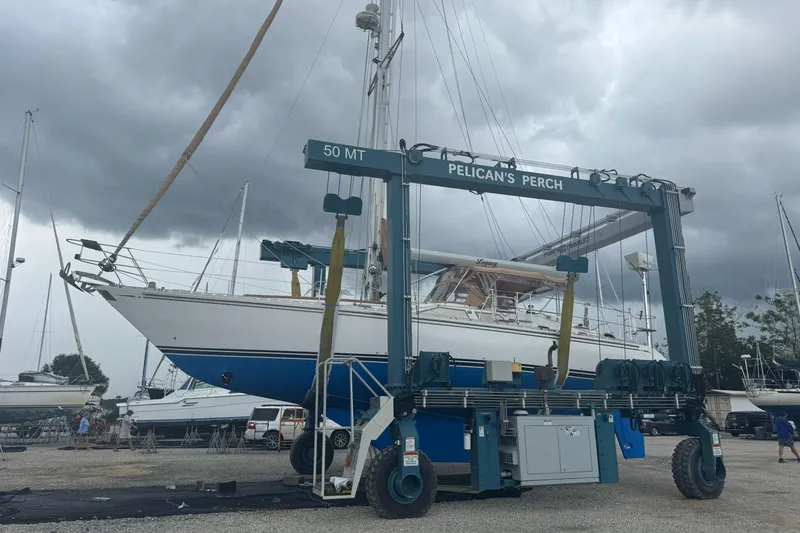 Slide: The Image of Sailboat Hylas 49CC 2012 in boatyard lift, cloudy sky background. - 201