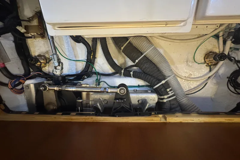 Slide: The Image of Engine compartment of a 2012 Hylas 49CC yacht, showcasing mechanical components and wiring. - 203