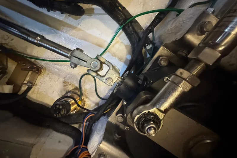 Slide: The Image of Engine compartment of a 2012 Hylas 49CC yacht, showing mechanical components and wiring. - 204