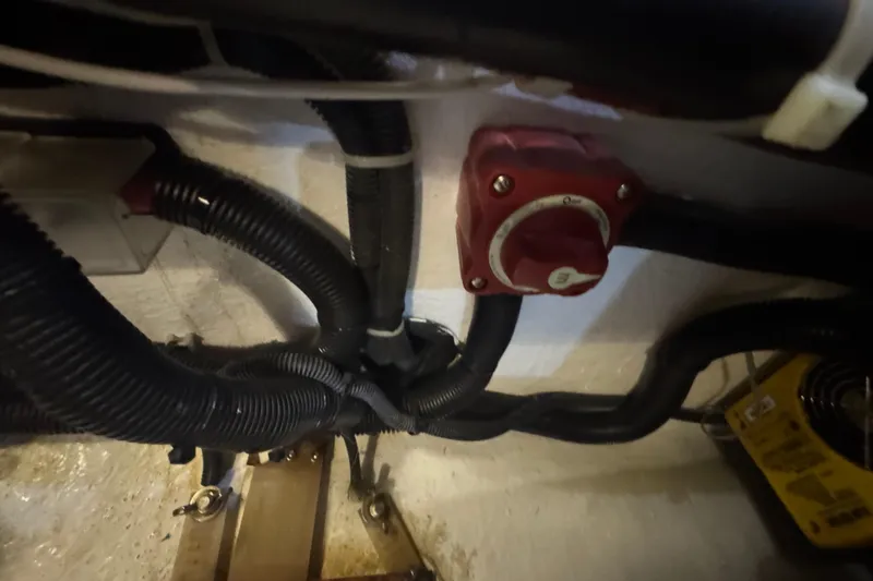 Slide: The Image of Engine compartment of a 2012 Hylas 49CC with wiring and a red control switch. - 206