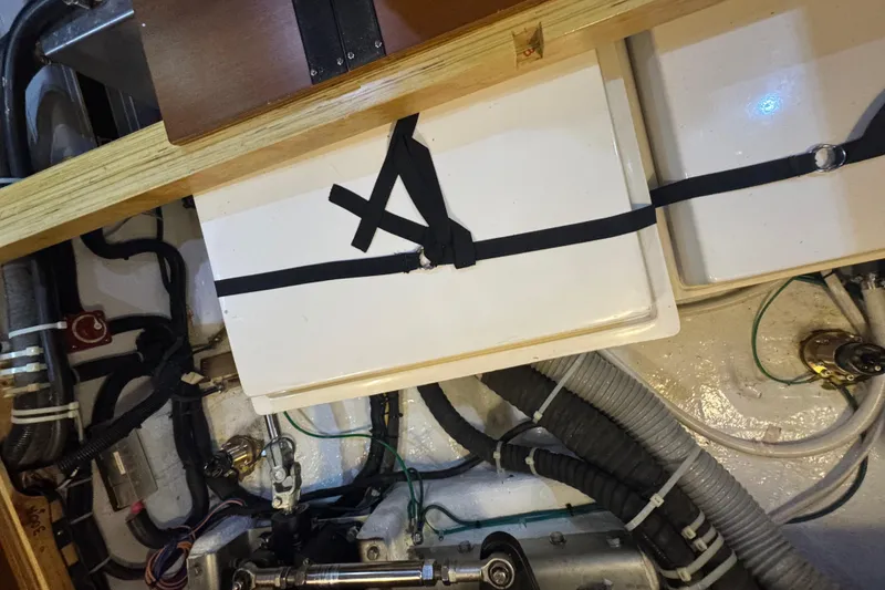 Slide: The Image of Engine compartment of a 2012 Hylas 49CC yacht, featuring secured components and wiring. - 208