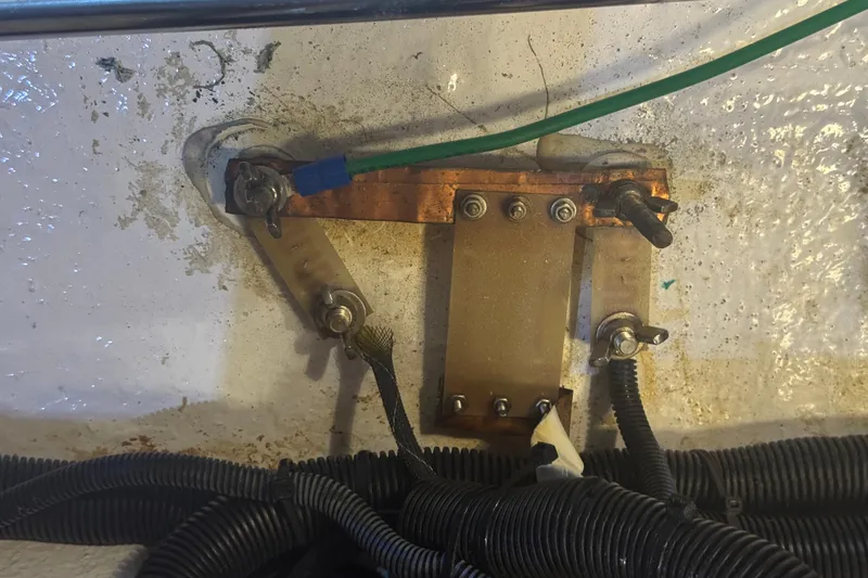 Slide: The Image of Electrical grounding setup on a 2012 Hylas 49CC boat, featuring wires and connectors. - 211