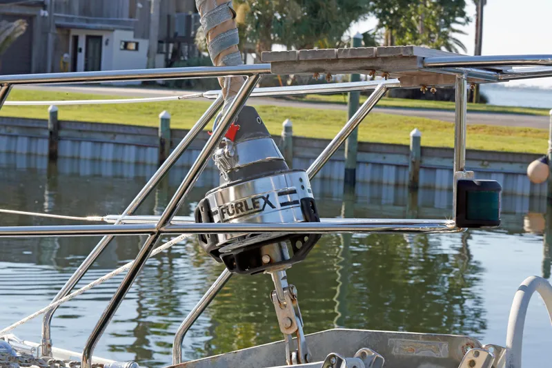 Slide: The Image of Stainless steel furling system on a 2012 Hylas 49CC sailboat by the water. - 22