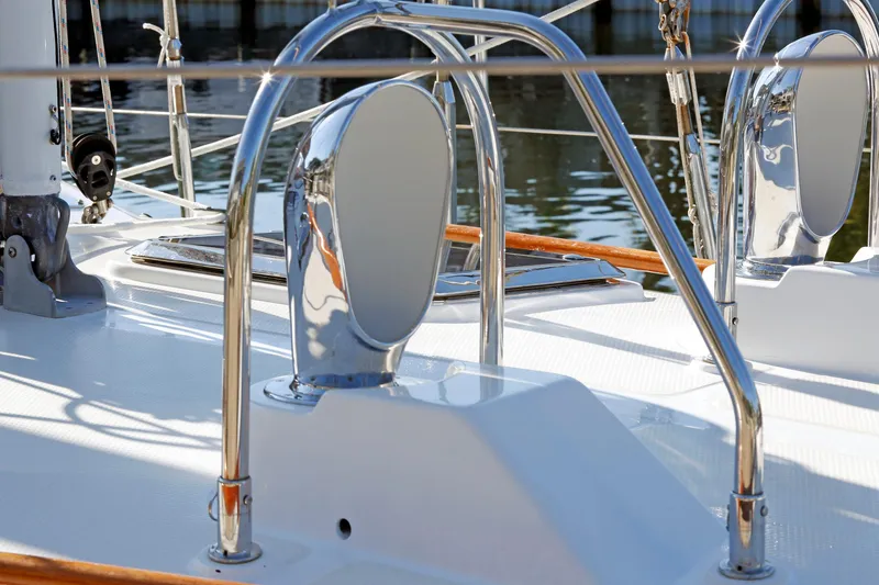 Slide: The Image of Polished deck details of a 2012 Hylas 49CC yacht, featuring chrome fittings and sleek design. - 24