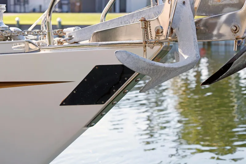 Slide: The Image of Close-up of a 2012 Hylas 49CC yacht's anchor and bow, docked by the water. - 37