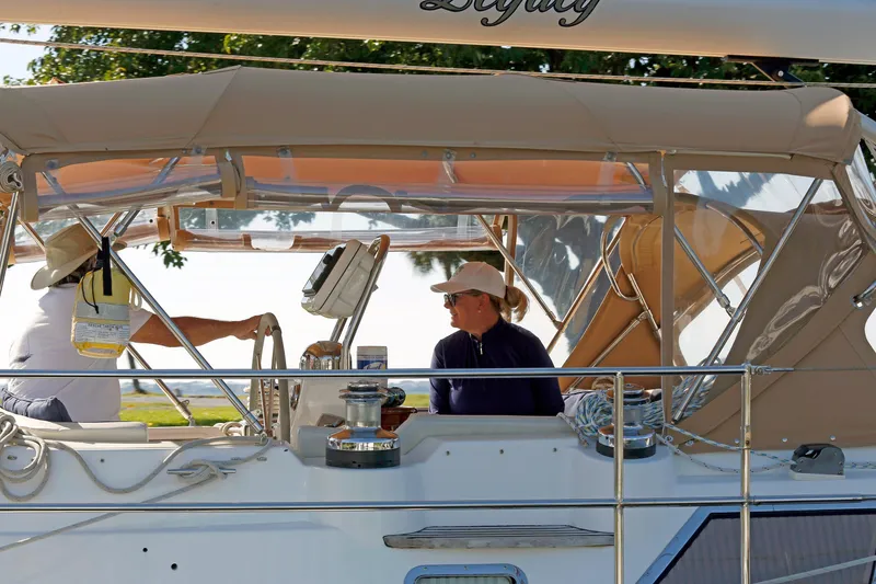 Slide: The Image of People relaxing on a 2012 Hylas 49CC sailboat under a canopy. - 40