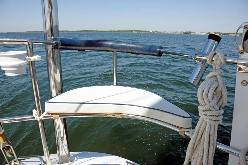 Slide: The Image of Sailboat deck view with cushioned seat, ropes, and ocean backdrop, Hylas 49CC, 2012 model. - 43