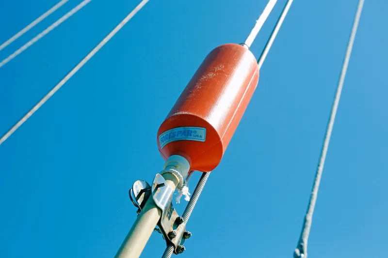 Slide: The Image of Red marine buoy on Hylas 49CC sailboat, 2012 model, against clear blue sky. - 46