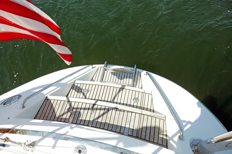 Slide: The Image of Stern view of 2012 Hylas 49CC yacht with American flag over water. - 47