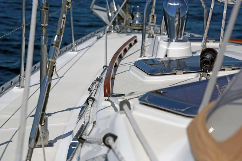 Slide: The Image of Deck view of 2012 Hylas 49CC sailboat with polished fittings and ocean backdrop. - 58