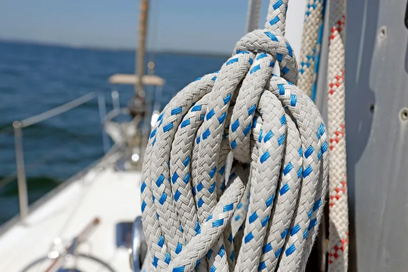 Slide: The Image of Coiled ropes on a 2012 Hylas 49CC sailboat deck, with ocean in background. - 64